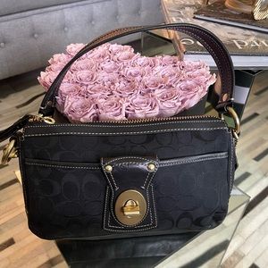Black coach handbag with white stitching and gold hardware